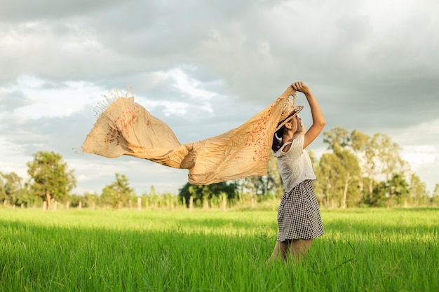 Asian women with a scarf in a meadow