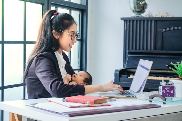 Asian women working in business and raising children at home