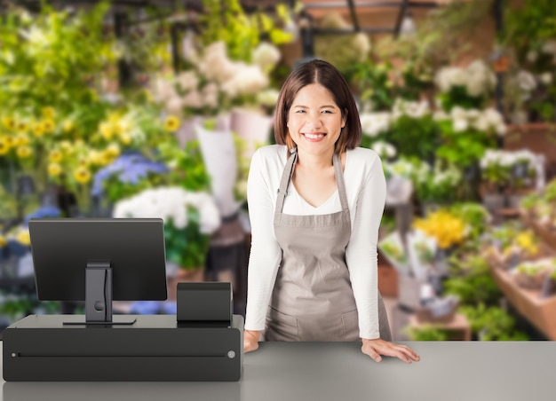 Asian worker with 3d rendering cashier desk in store