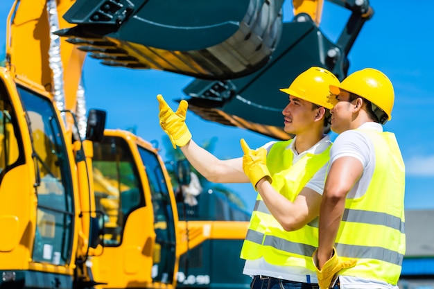 Asian workers on construction site