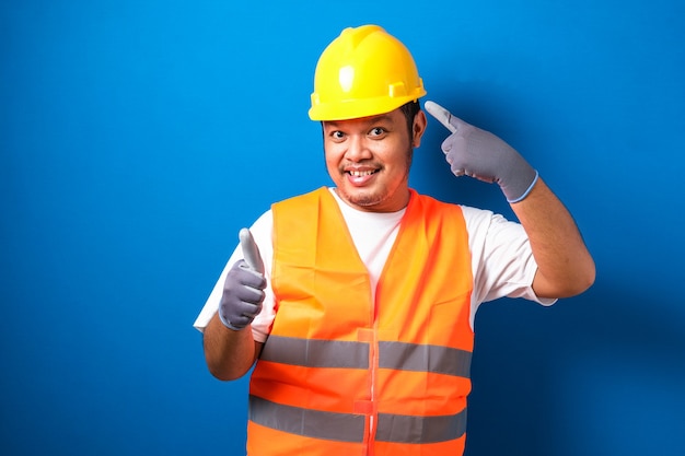 Asian workers wearing helmets are seen looking for ideas in completing work 