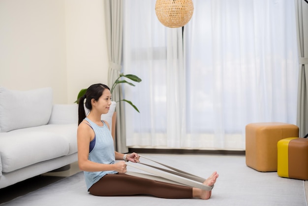 Asian do workout with resistance band at home