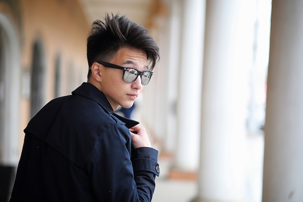 Asian young adult man on street posing at the camera
