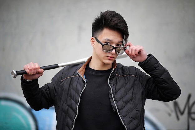 Asian young adult man on street posing at the camera