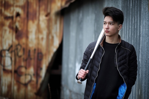 Asian young adult man on street posing at the camera