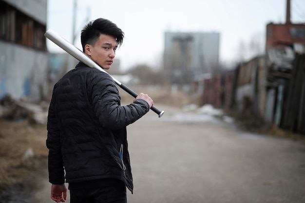 Asian young adult man on street posing at the camera