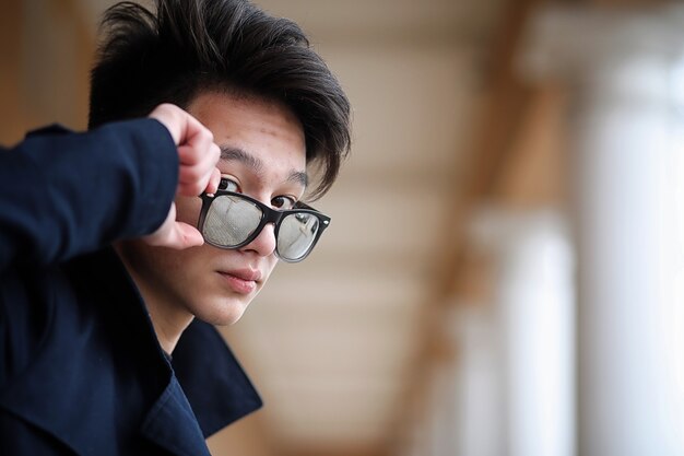 Asian young adult man on street posing at the camera