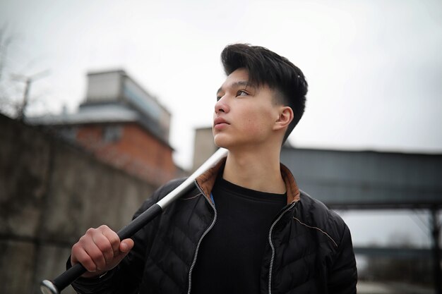 Asian young adult man on street posing at the camera