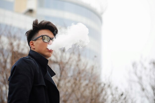 Asian young adult man on street posing at the camera