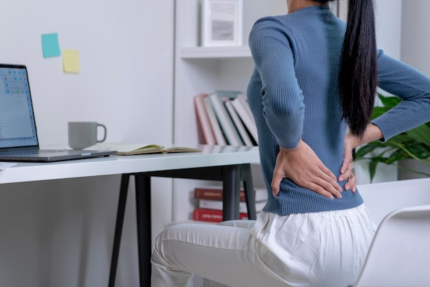 Asian young attractive woman pain with back pain ache from computer work