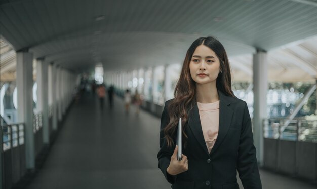 Asian young beautiful businesswoman walking outdoor