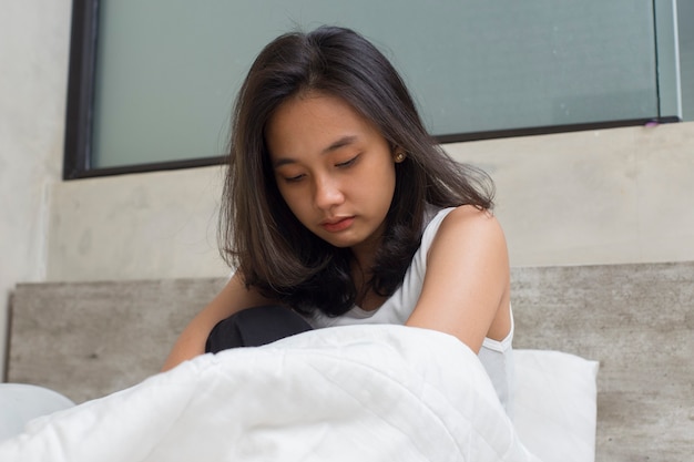 Asian young beautiful women look sad disappointed and lonely at home