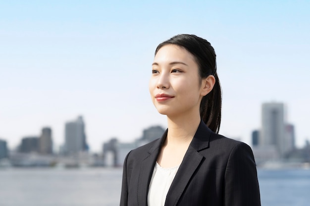 Asian young business woman and tokyo city scape in fine day