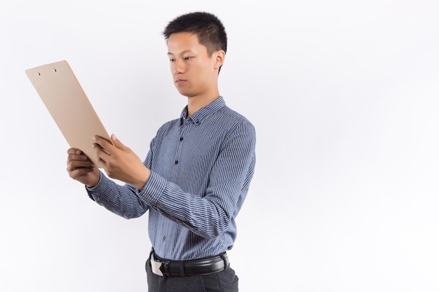 Asian Young Businessman take note on clipboard