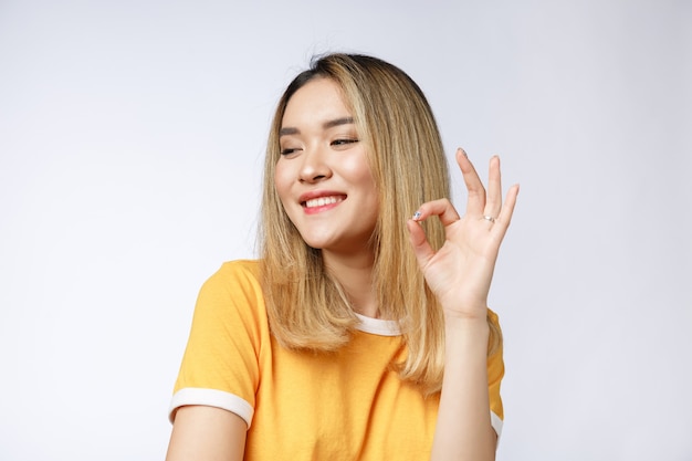 Asian young Businesswoman with ok sign gesture.