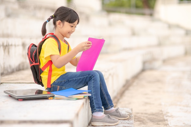 Asian young girl read a book ,Learning skills concept.