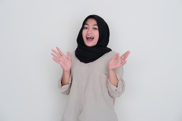 Asian young girl wearing hijab showing cheerful expression