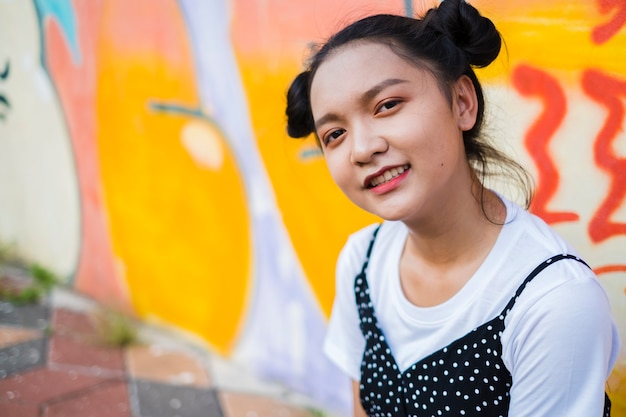 Asian young girl with colorful wall Happy girl