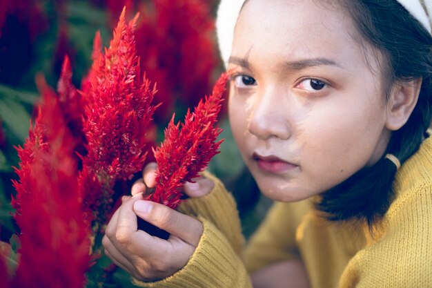 Asian young girl with red flowers