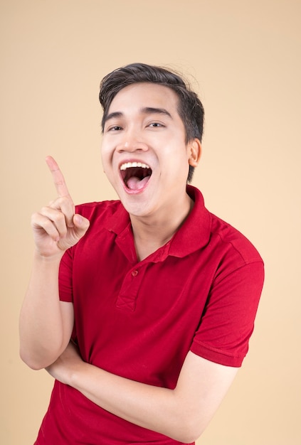 Asian young handsome and cheerful male student with hand gesture