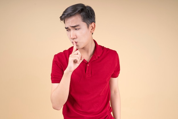Asian young handsome and cheerful male student with hand gesture