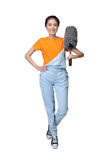 Photo asian young housewife holding feather duster