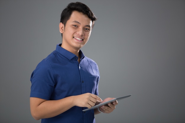 Asian Young Man in Casual using tablet