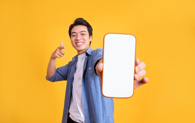 Asian young man posing on a yellow background