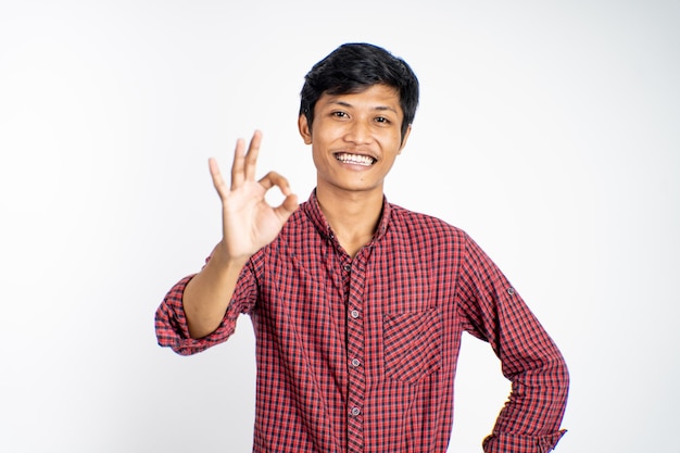 Asian young man showing thumbs up with smiling teeth