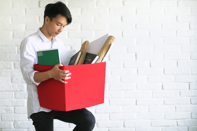 Asian young man student with books in hands