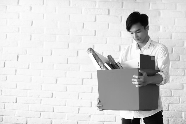 asian young man student with books in hands