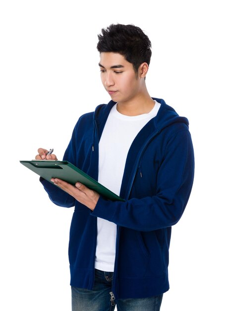 Asian young man take note on clipboard