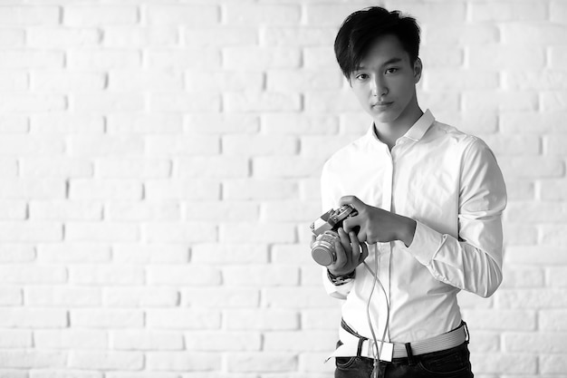 Asian young man uses a camera in the studio