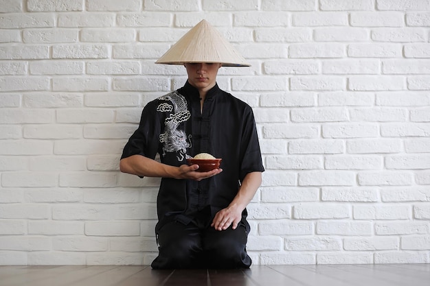 Asian young novice on a white brick wall background