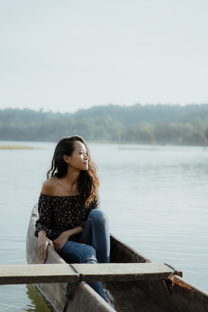 Asian young woman canoeing on lake