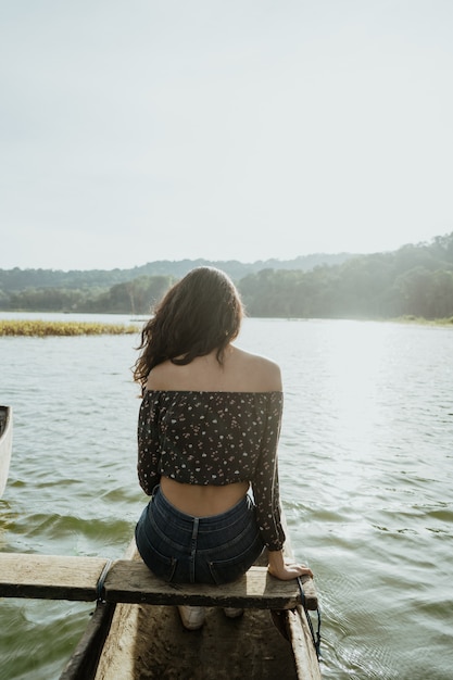 Asian young woman canoeing on lake