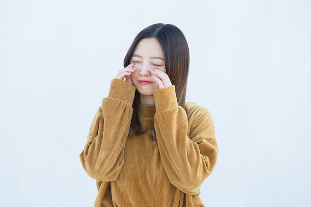 Asian young woman crying on white background