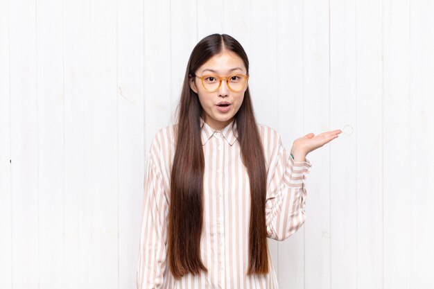 Asian young woman looking surprised and shocked