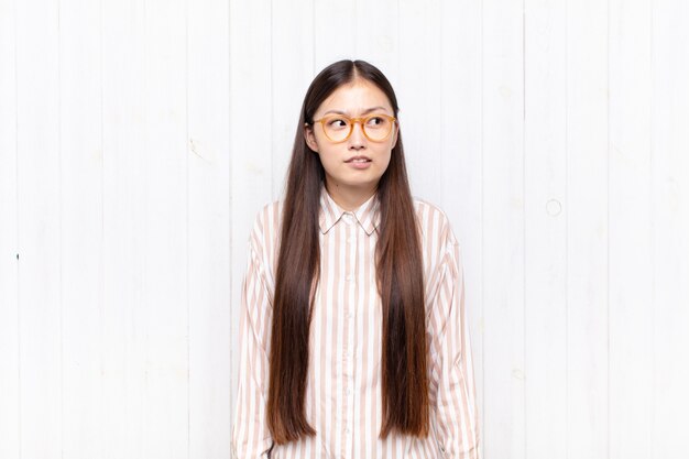 Asian young woman looking worried, stressed, anxious and scared, panicking and clenching teeth