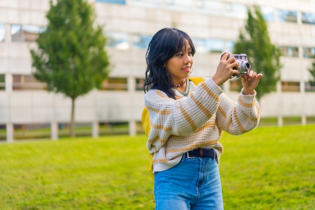 Photo asian young woman photography with a vintage photo camera backpacking traveler concept