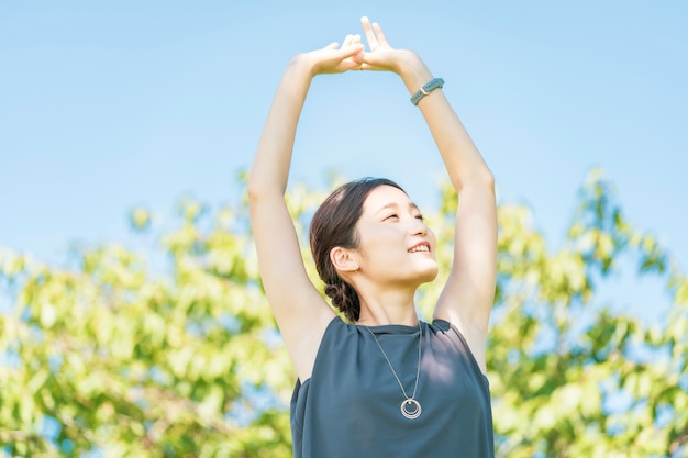 Asian young woman relaxing in the green