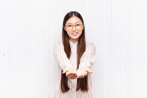 Asian young woman smiling happily with friendly