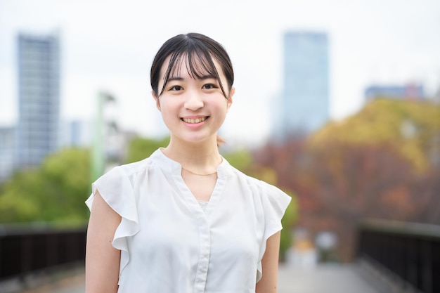 Asian young woman smiling outdoors