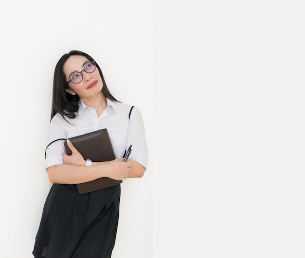 Asian young woman thinking beautiful smile put a white shirt stand 