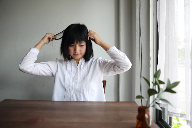 Asian young woman thinking and looking portrait in coffee shop cafe