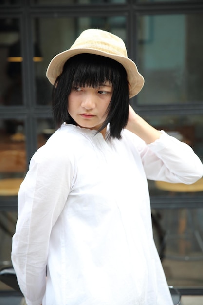 Asian young woman thinking and looking portrait with in coffee shop