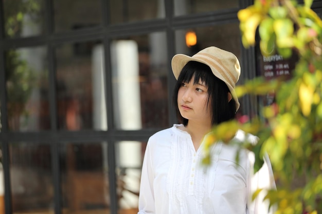 Asian young woman thinking and looking portrait with in coffee shop