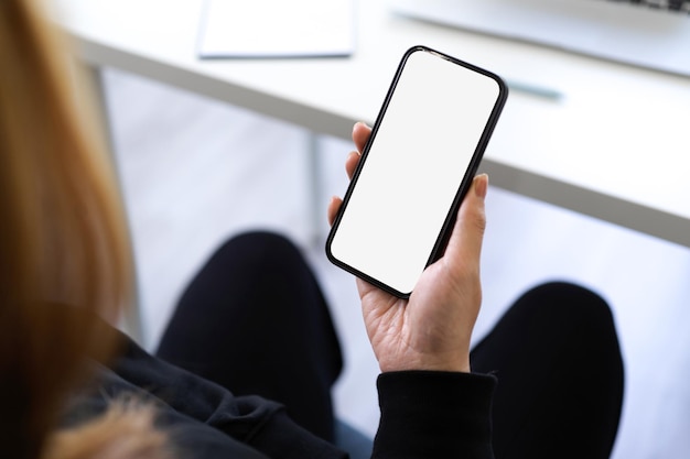 An asian young woman using smartphone to contact with her family. mobile phone blank screen. closeup