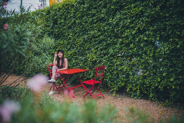 asian younger woman sitting in green park