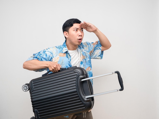 Asianl man beach shirt hold luggage hand at head for looking feels excited